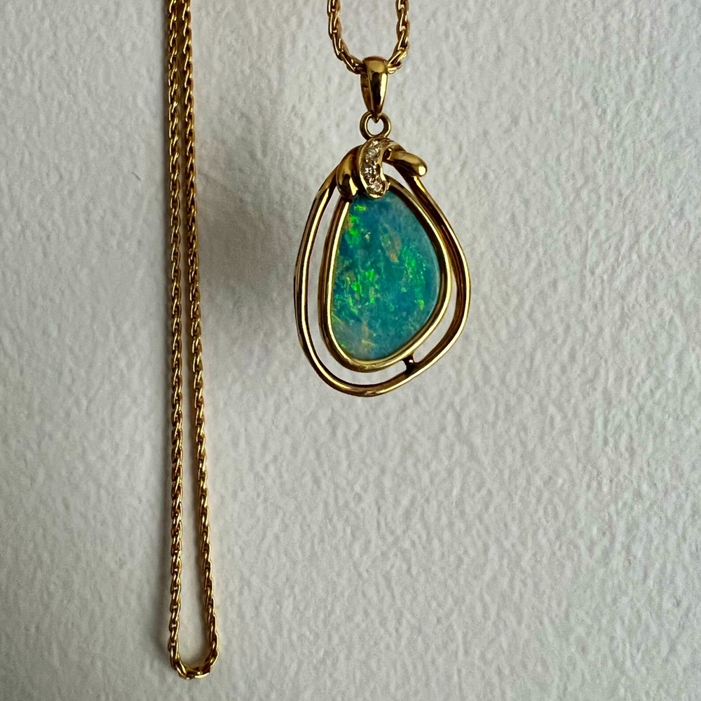 14k Yellow Gold Opal Pendant With a Kidney Shaped Cabochon Cut Black Opal